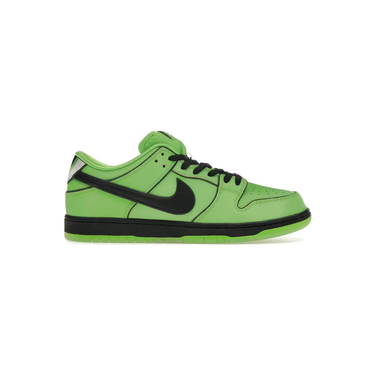 The Nike SB Dunk Low Powerpuff Buttercup worn with casual streetwear. The vivid green and black color scheme pops against an urban background, highlighting the sneaker's bold style and skateboarding heritage.