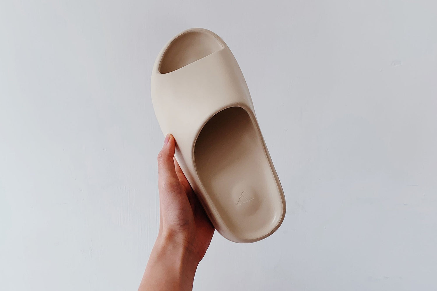 Close-up of Yeezy Slides worn with casual streetwear, showcasing the sleek, minimalist design and comfort-focused silhouette.